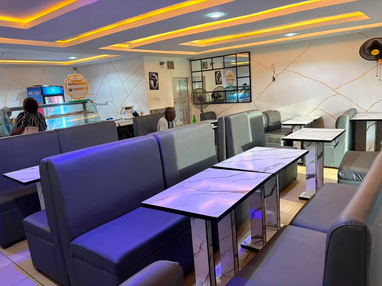 Dining room booths and marble tables looking towards the service counter