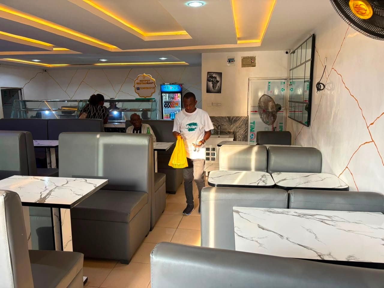 A takeaway order bagged at the counter with the dining room behind